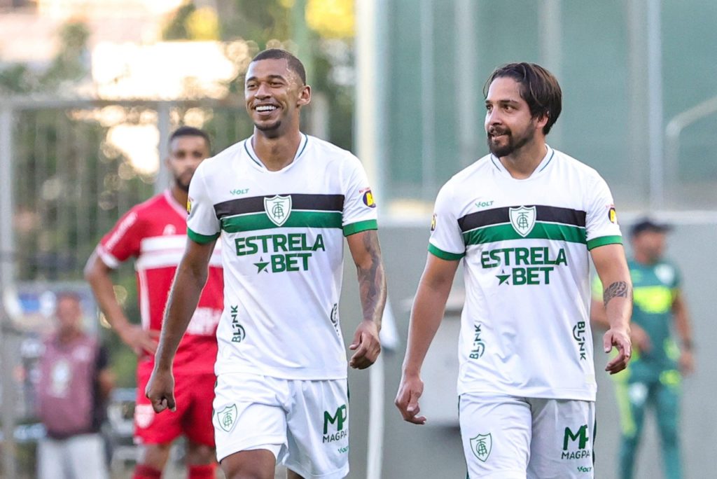 Fabinho, do América-MG, comemorando um dos gols marcados pelo time ao lado de um companheiro.